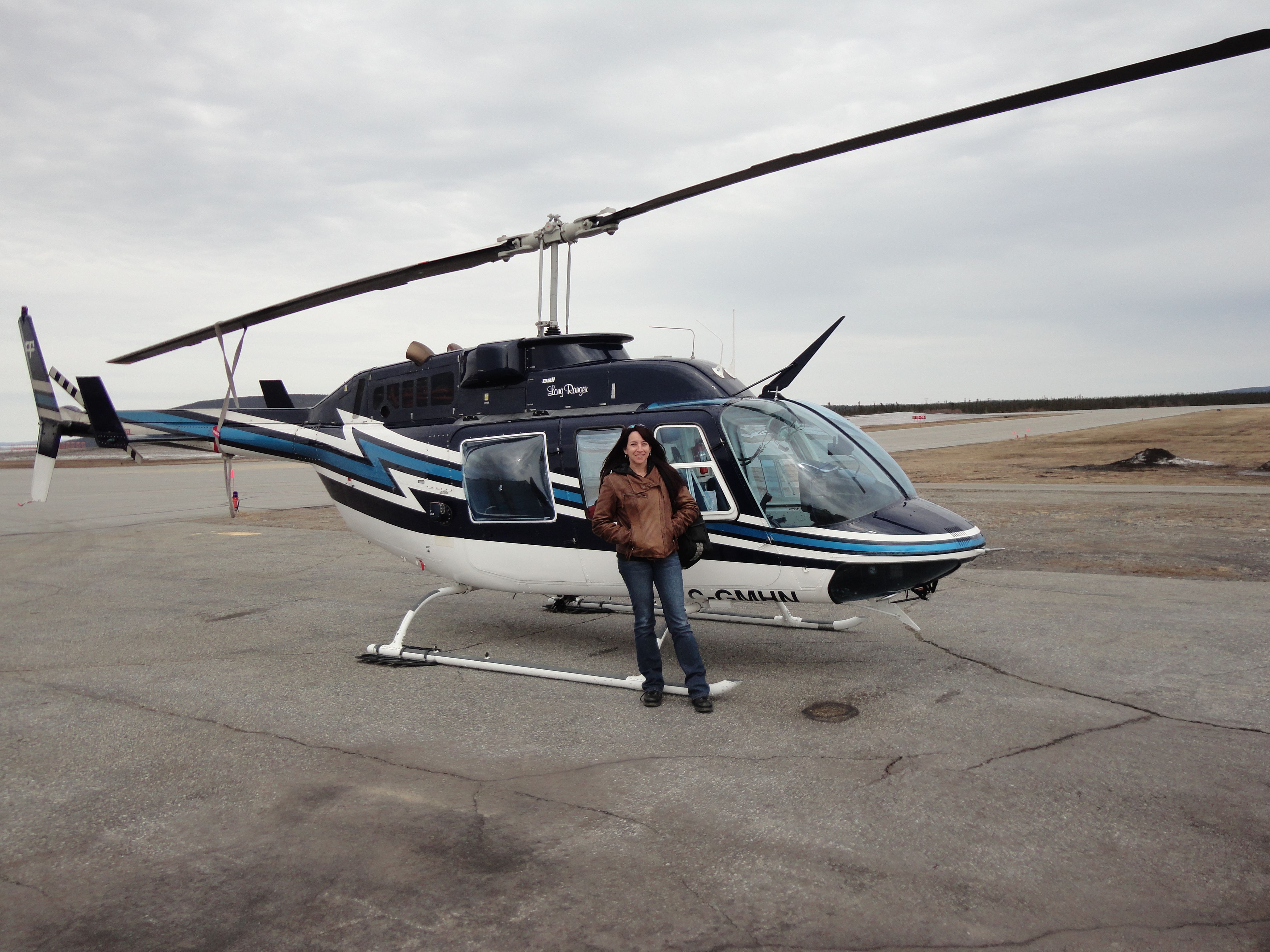 Johanna LeRoux standing in front of the helicopter that will take her on the last leg of the journey to Churchill Falls to speak about the importance of workplace safety and injury prevention.