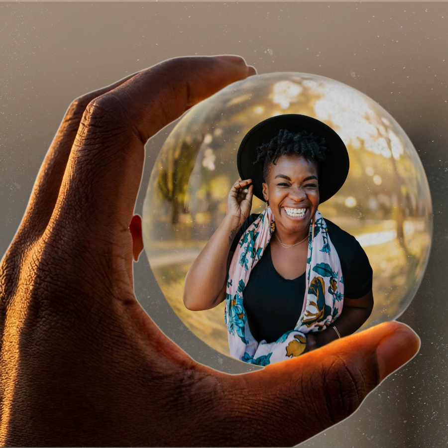 A radiant Black woman with natural hair and a wide smile, seen through a glass orb held by a Black hand — representing clarity, self-reflection, and personal power in the soft girl era. Visual identity for The Clarity Code soft life skills assessment by mindset and lifestyle coach Rashidat.