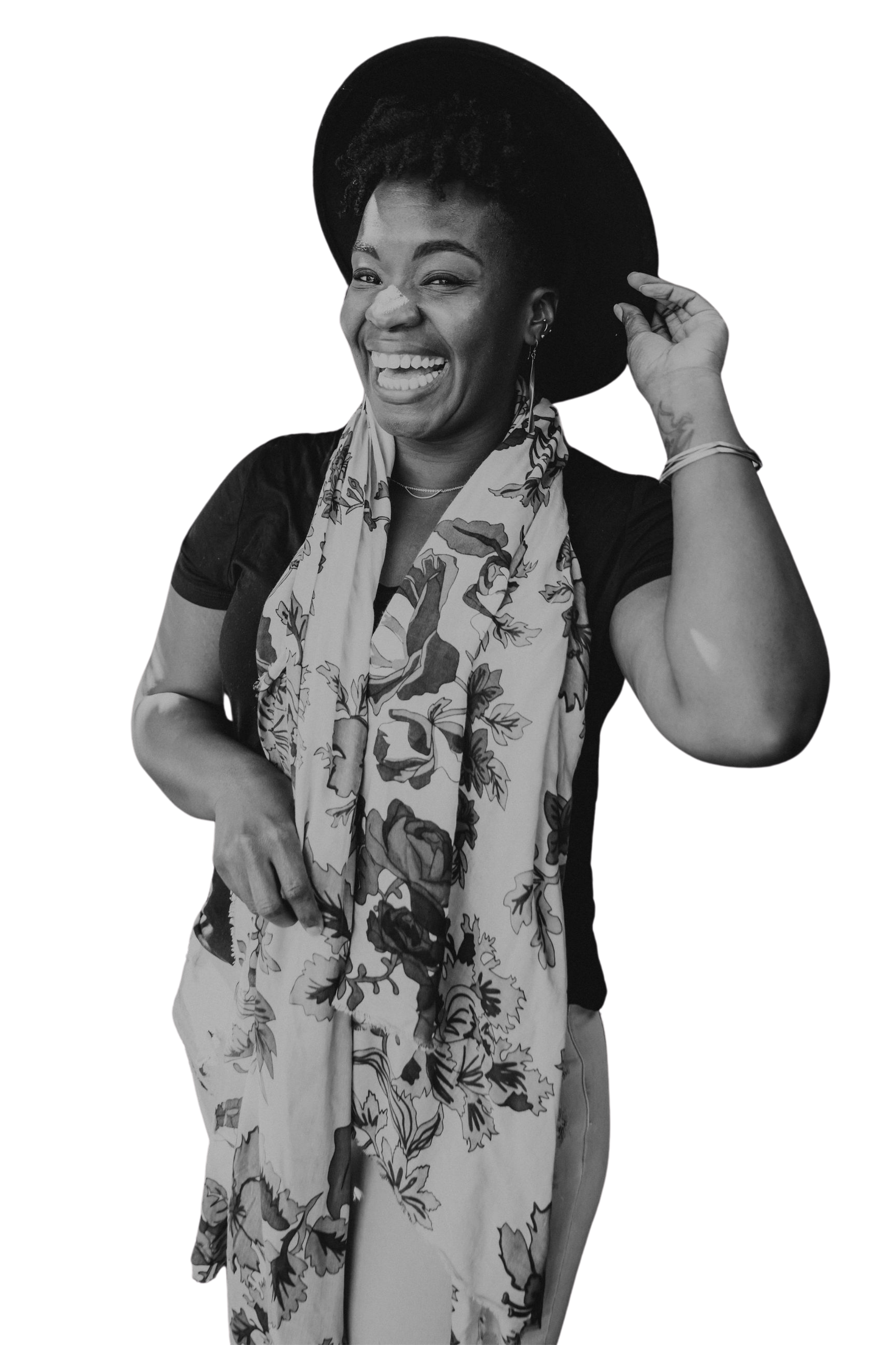 Rashidat, lifestyle coach for high-achieving women, smiling in a black wide-brim hat