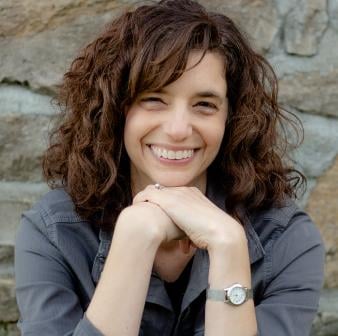 Headshot of Lois a woman with brown wavy hair