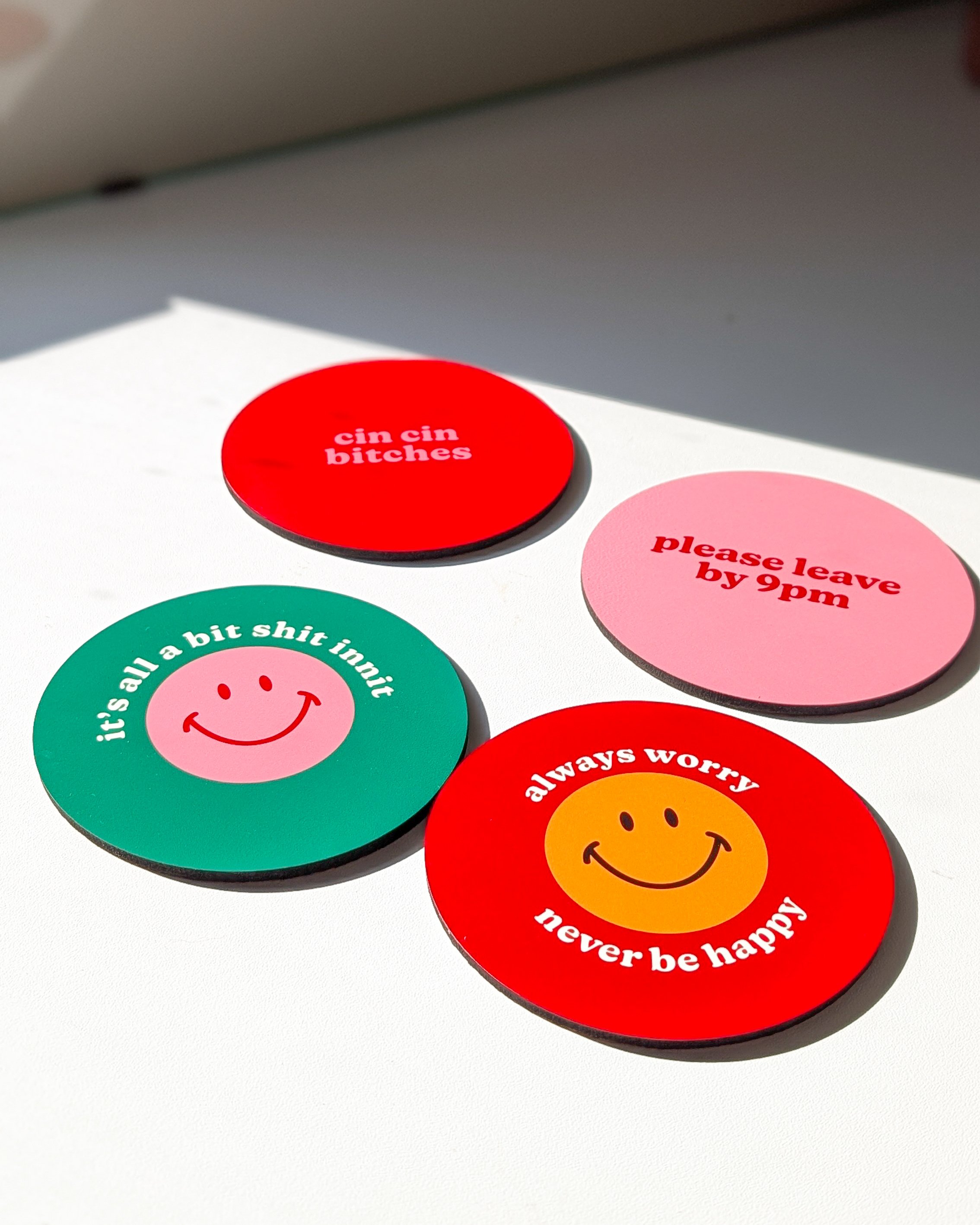 A hand holding a colourful wavey art print