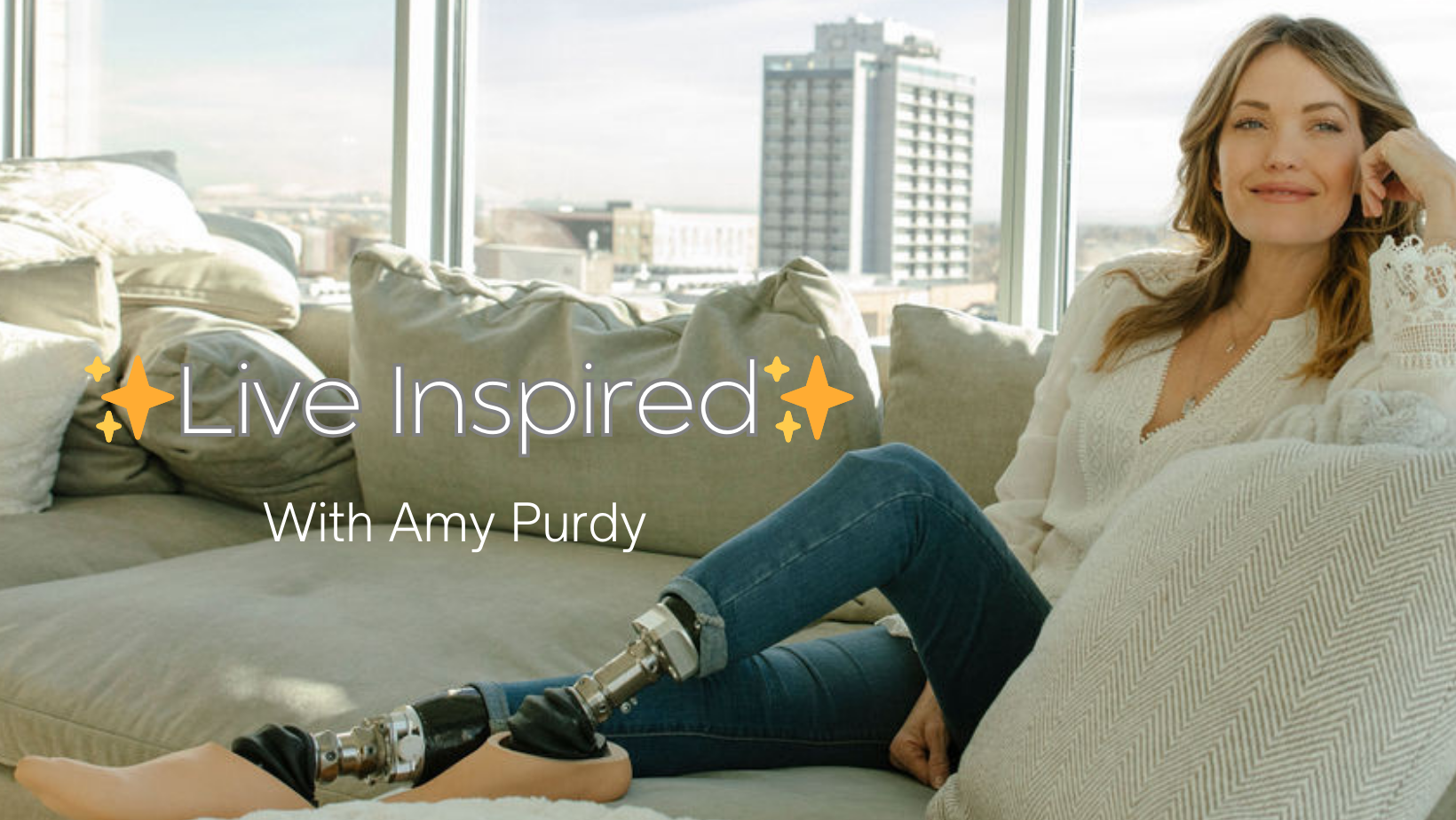 Amy Purdy sitting on her couch wearing blue jeans and a white top.