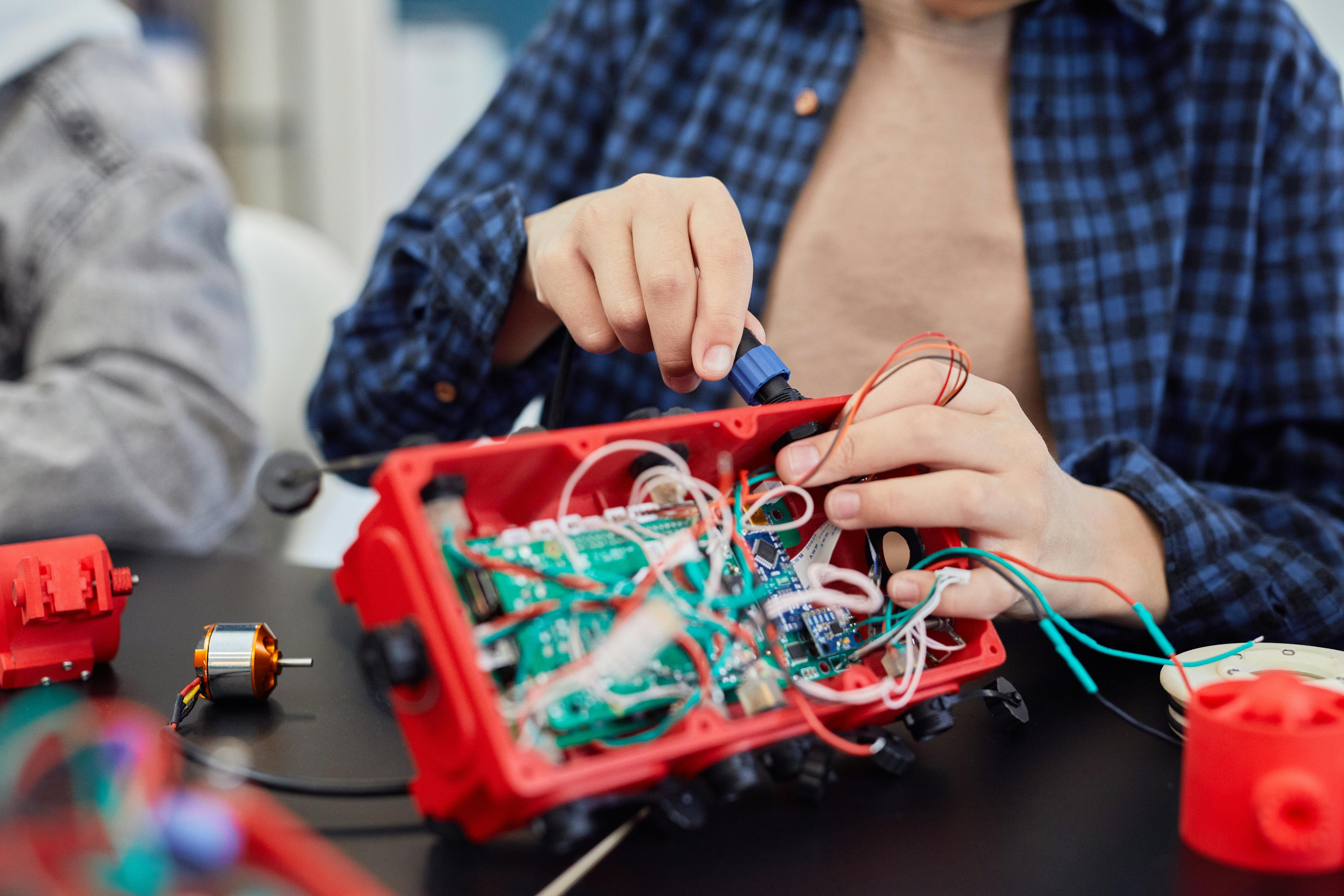 Person assembling electronics enclosure