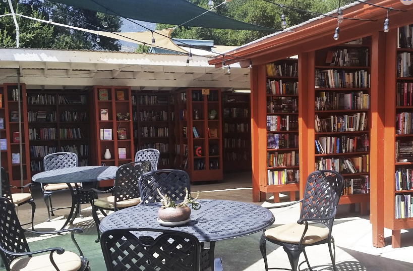 tables surrounded by bookcases filled with books