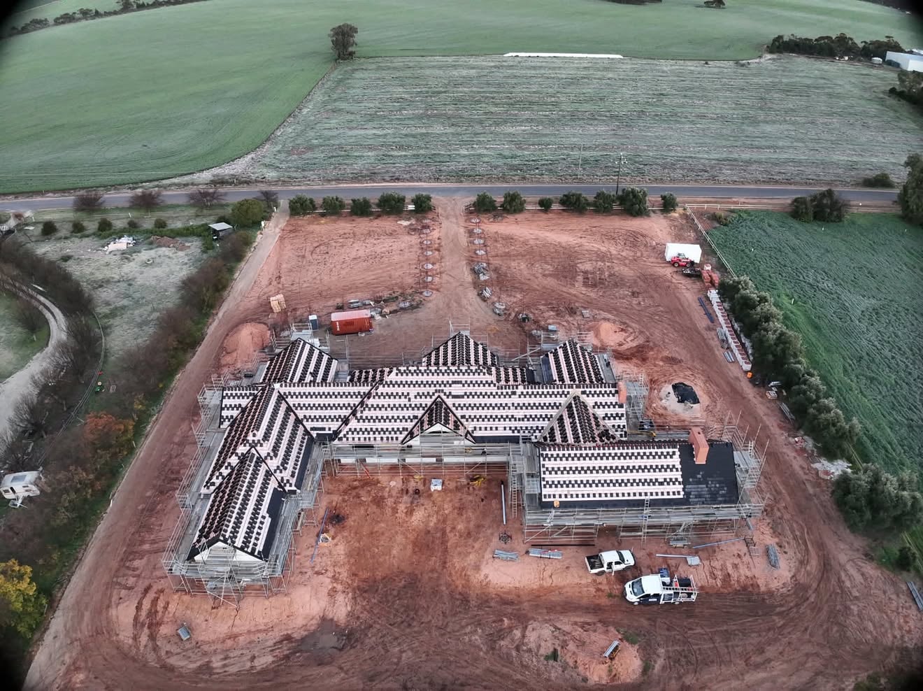 Aerial view of a large new home in Swan Hill with its tiled roof being installed by Reign Roofing