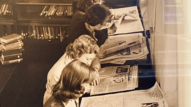 Young women proofreading the city newspaper