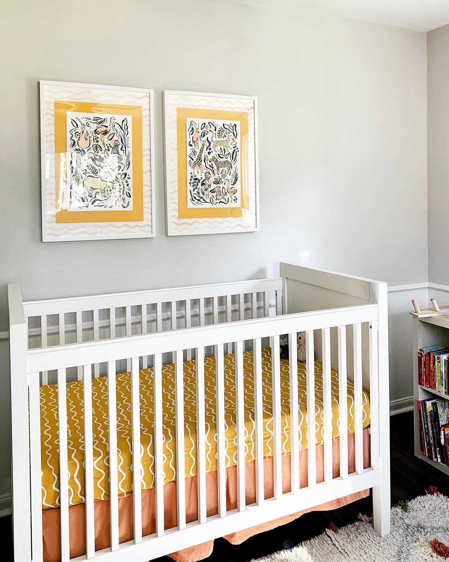 crib with safari jungle paintings over it by katie sinclair