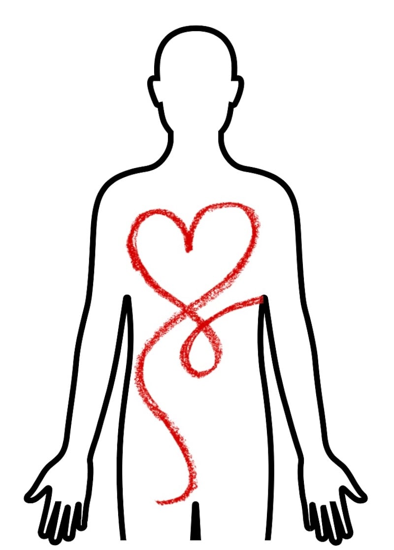 Professional female therapist at a public Self Love Immersion event wearing a black blazer, glasses and red lipstick, smiling at the camera