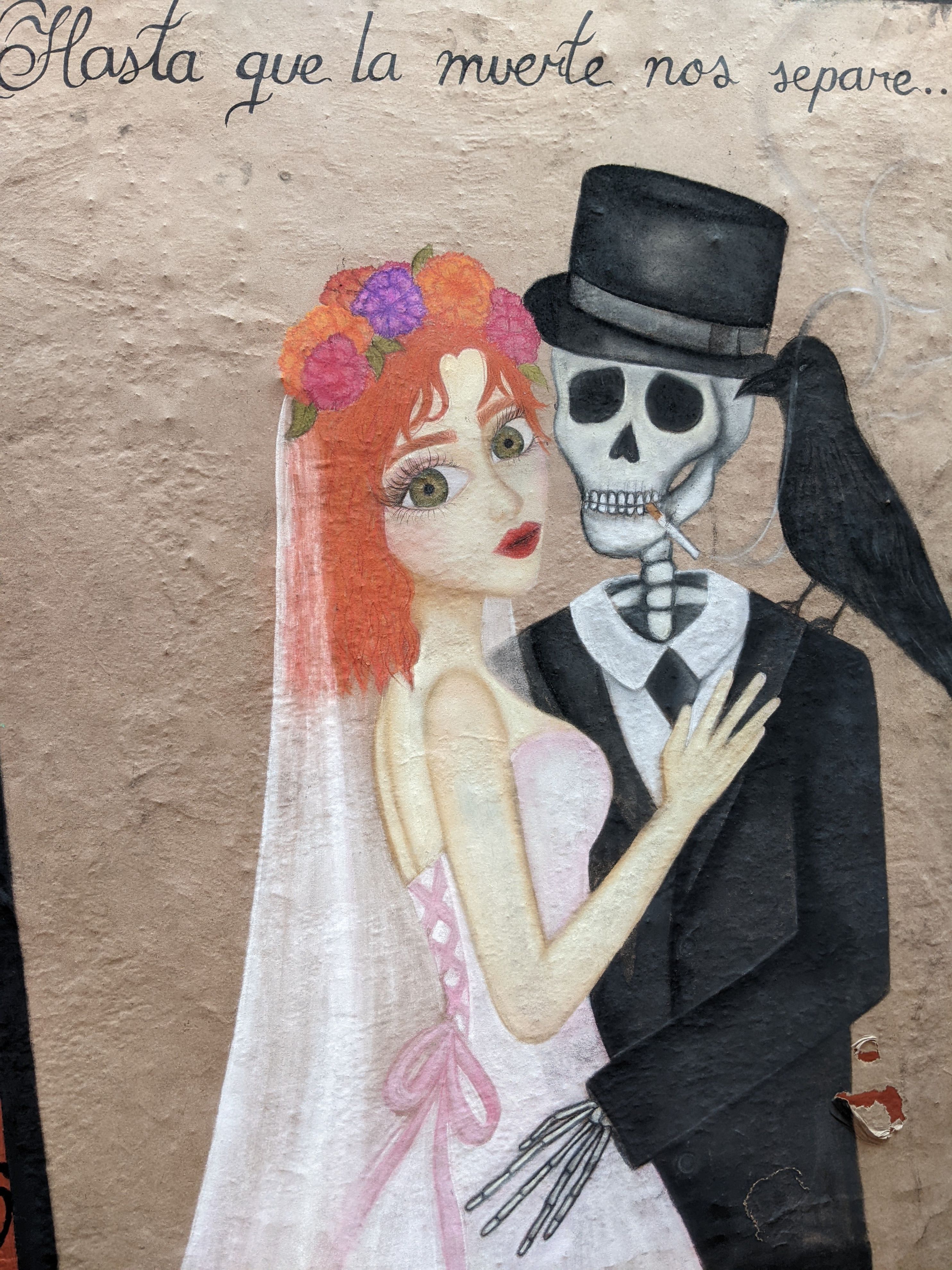 Mural from Guanajuato, Mexico, depicting a living bride embracing a skeleton groom. The text, translated to English, reads: "Until death do us part"
