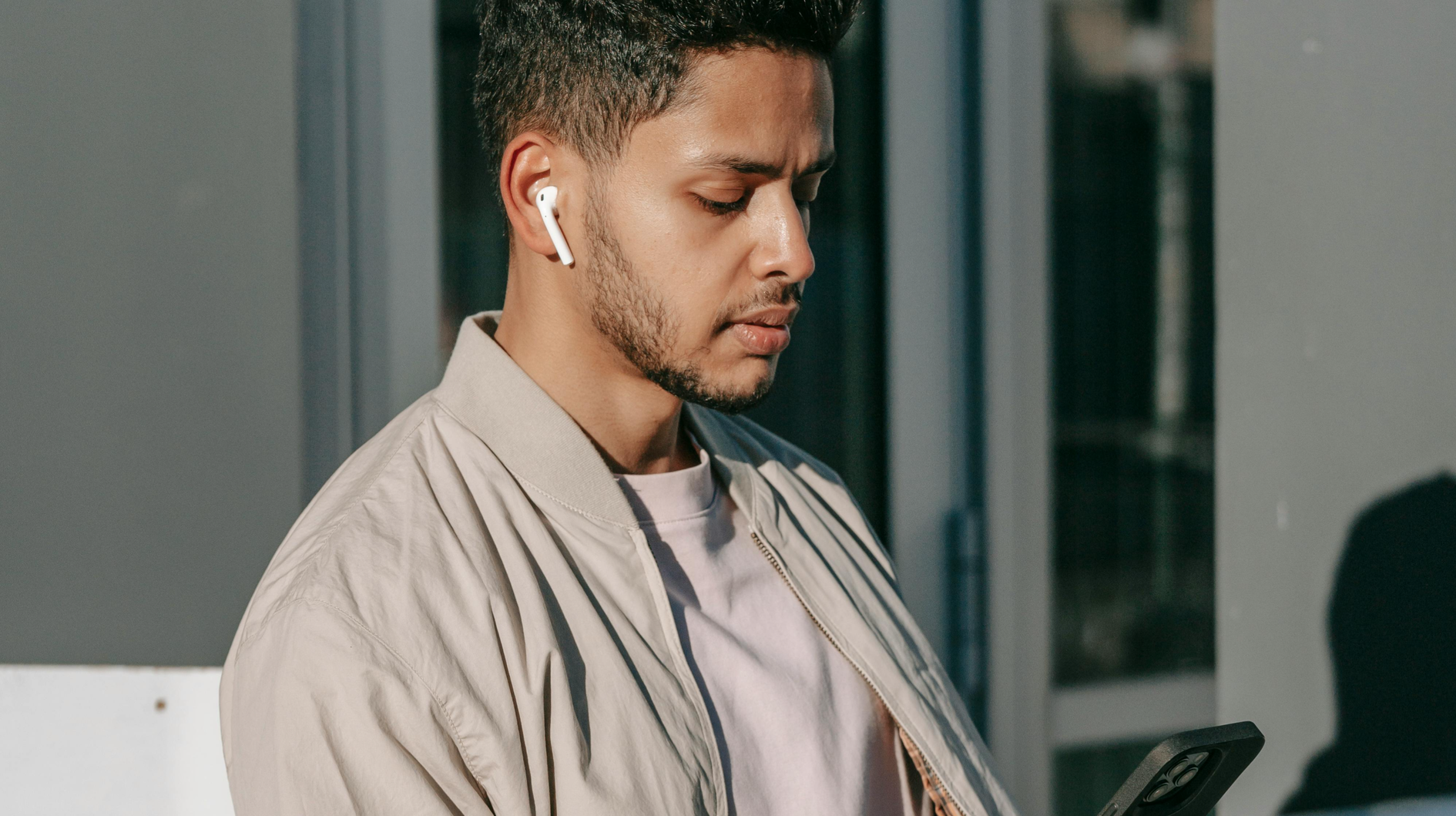Person seemingly stressed looking down at phone, representing reaching to audio on phone for relief