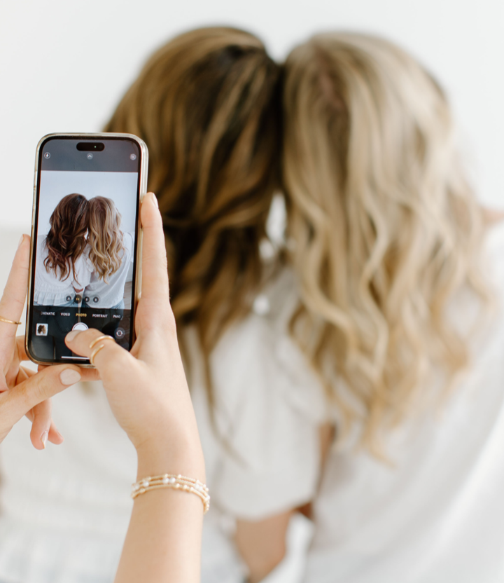 successful salon owner taking a picture of client's hair