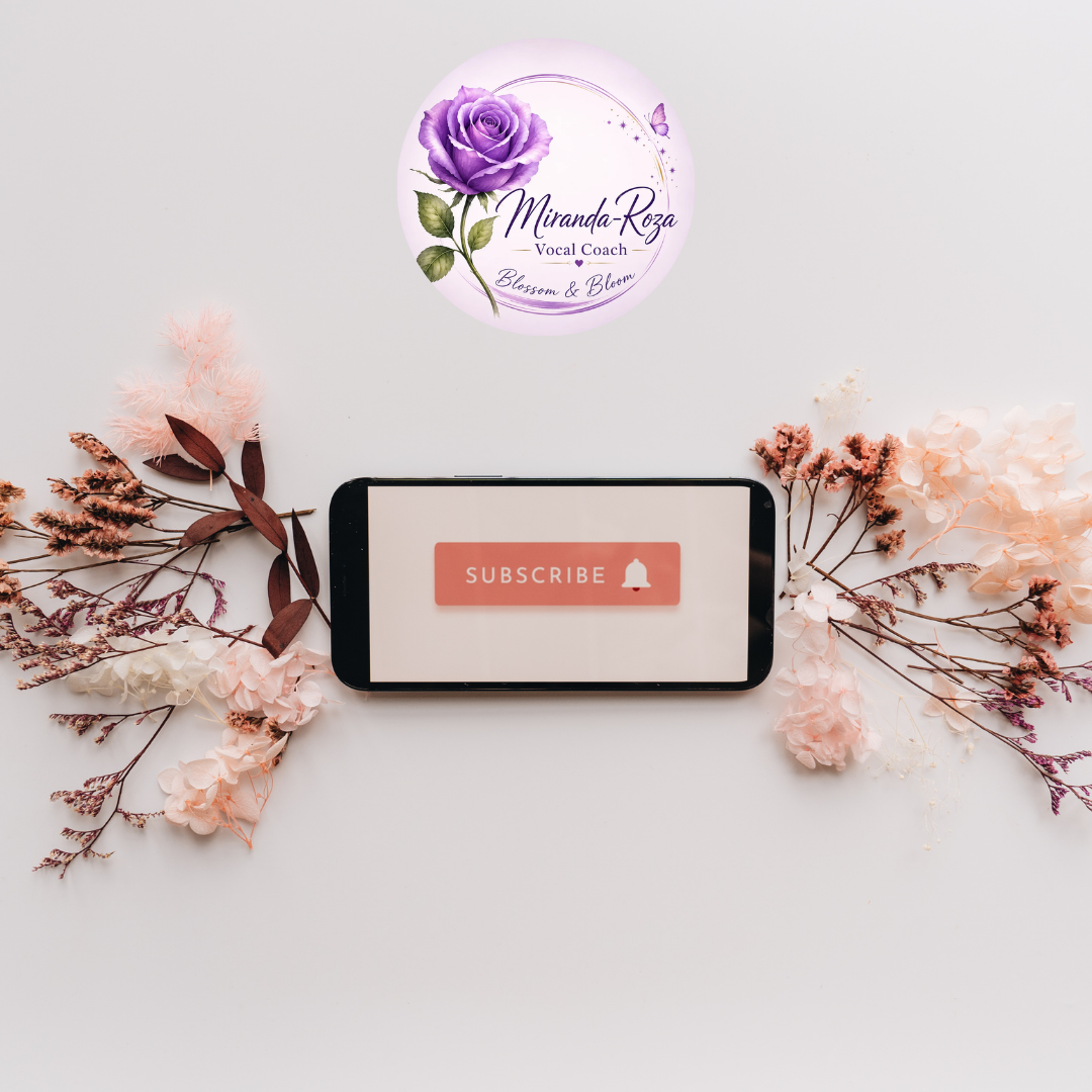 Miranda-Roza Vocal Coach YouTube subscribe graphic featuring the Miranda-Roza Vocal Coach logo with purple rose, surrounded by delicate flowers and a smartphone displaying a YouTube Subscribe button, promoting singing lessons, vocal health tips and singing content.