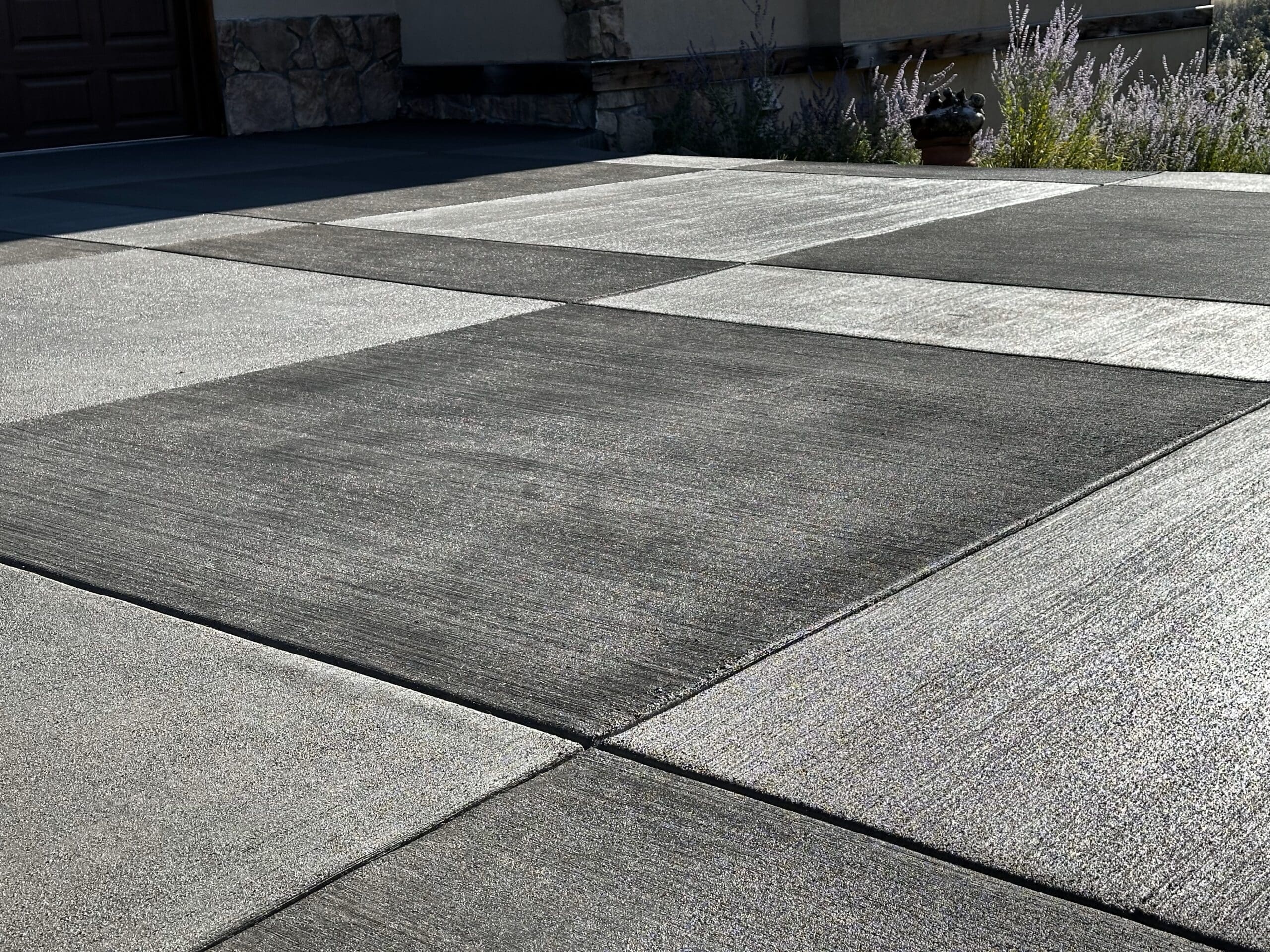 Black and white driveway created by a concrete contractor.