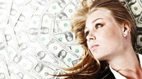 Woman with money around her signifying passive income and residual income.