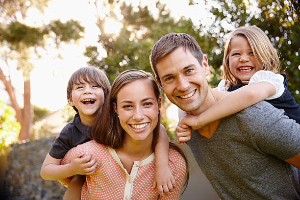 Family smiling, representing life insurance protection with a life insurance agent.