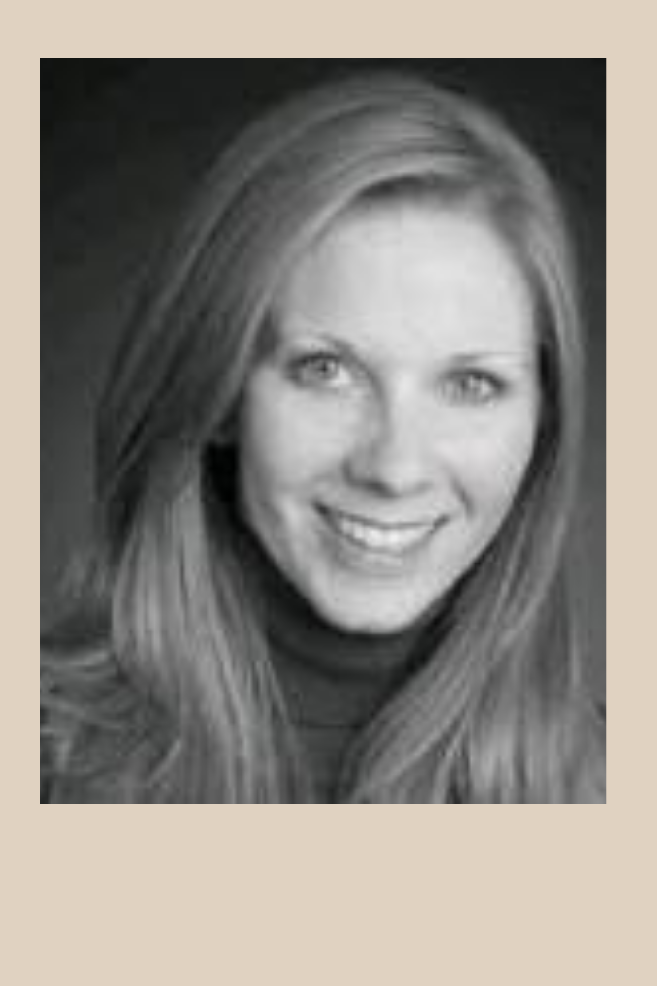 Photo of Michelle Martin. The photo is black and white. Michelle has long hair and is smiling. She is wearing a turtle neck.