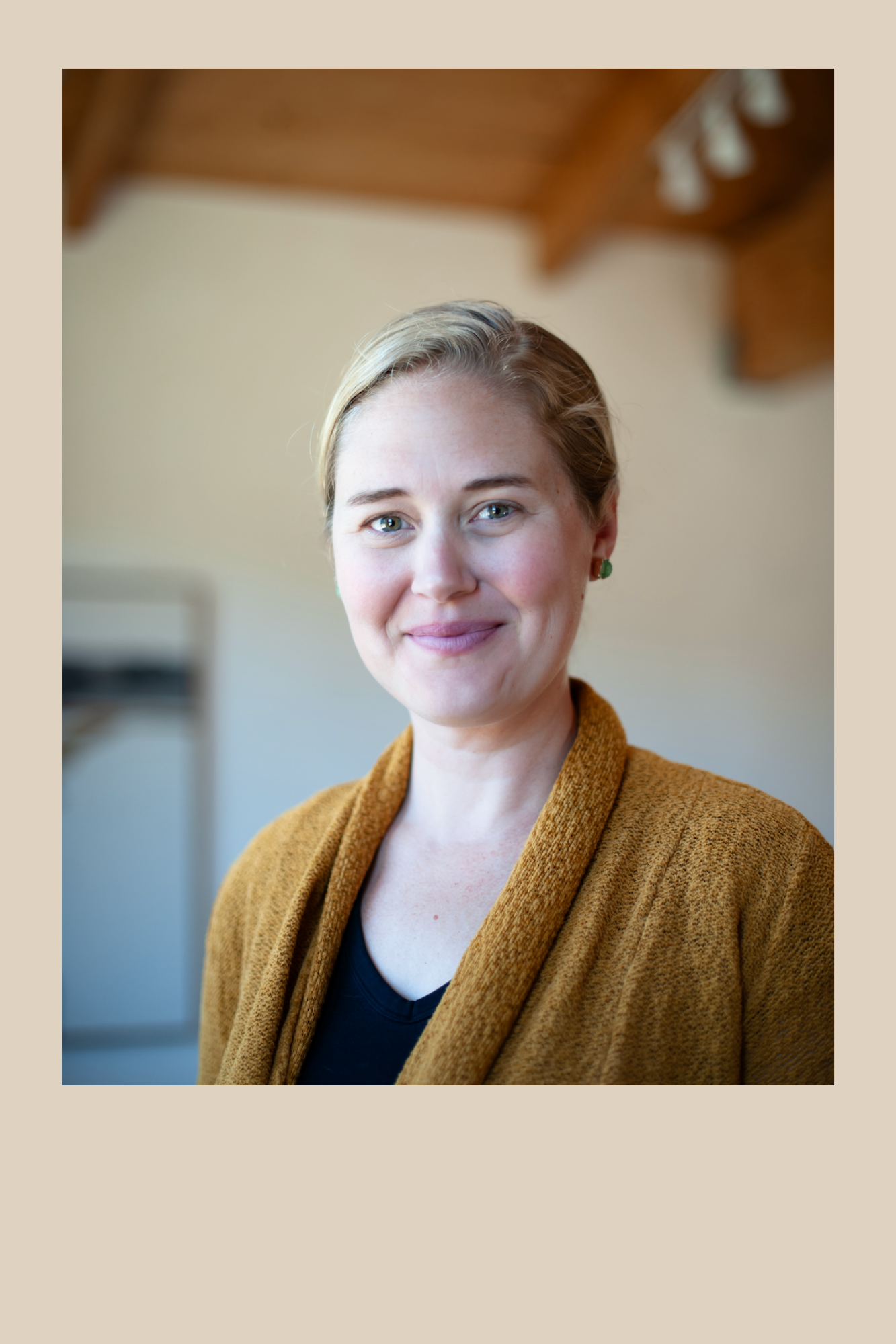 Headshot of Molly Morris. A woman with long blond hair pulled back. She is wearing a light tan sweater.