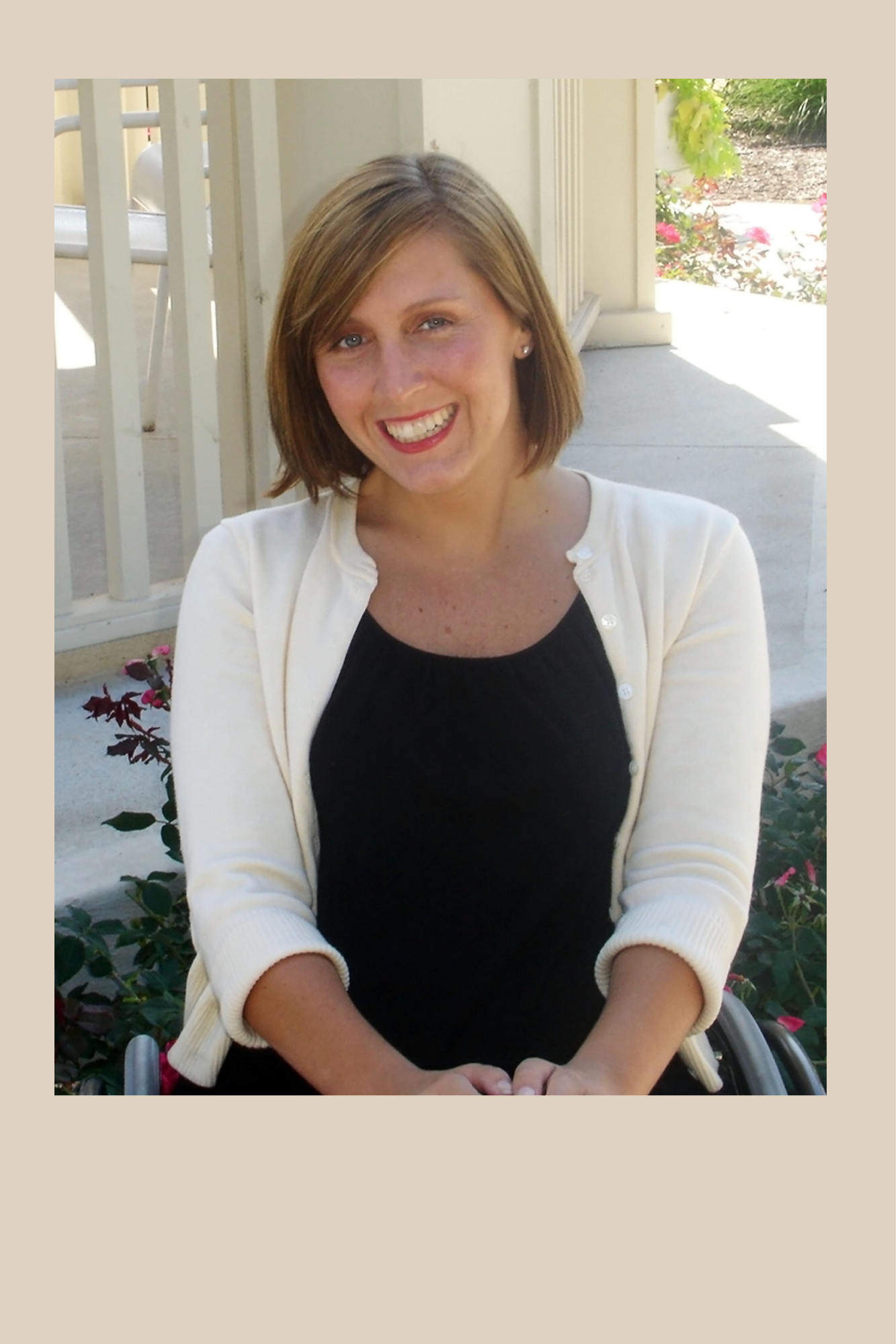 Picture of Amber OHaver: Middle aged women with midlength hair. Sitting in wheelchair near a gazebo. Wearing a yellow sweater and black shirt. Smiling.