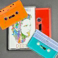 Three colourful custom cassette tapes and illustrated cover art on a grey background
