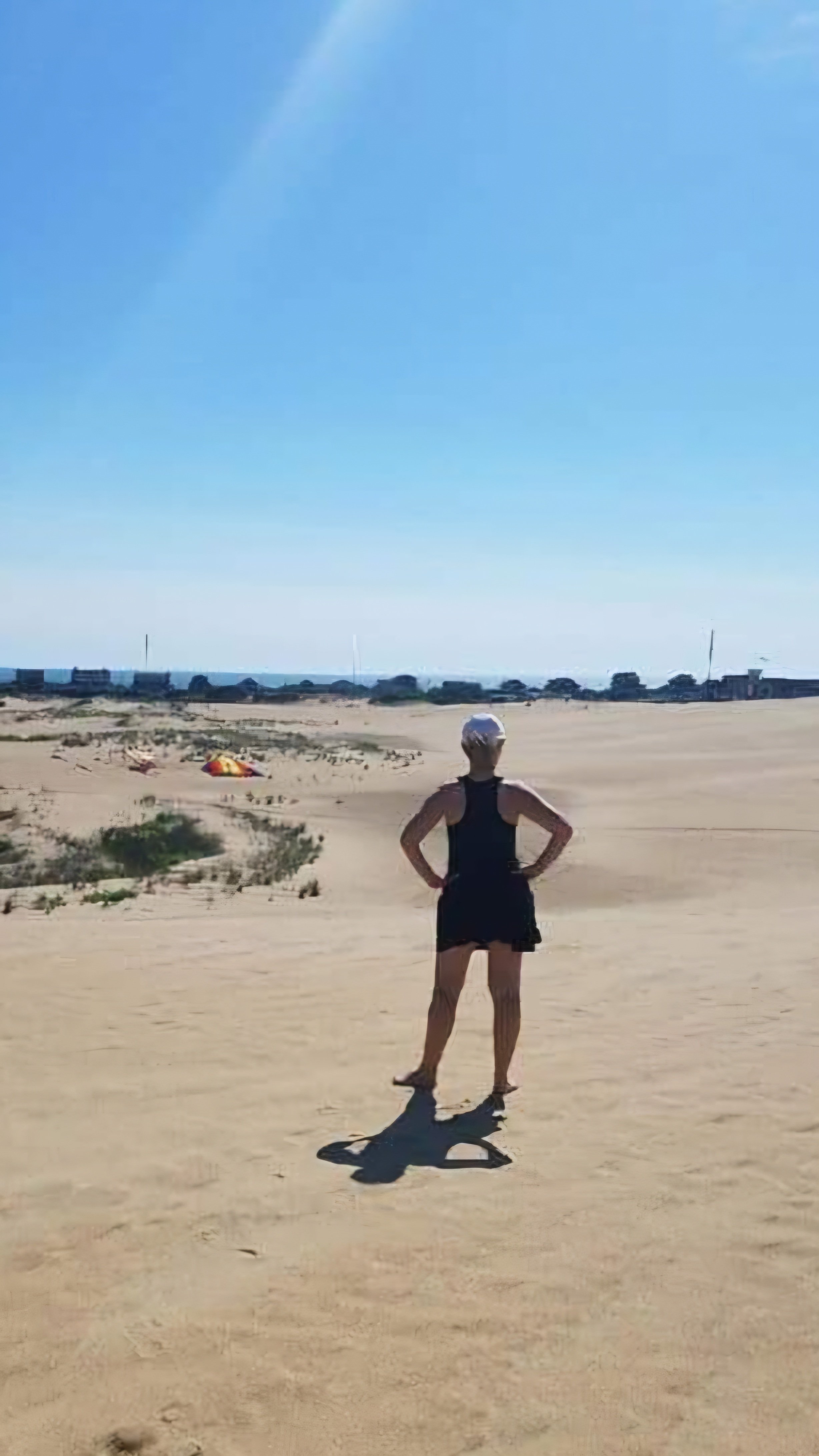 Coach Mary V standing on beach