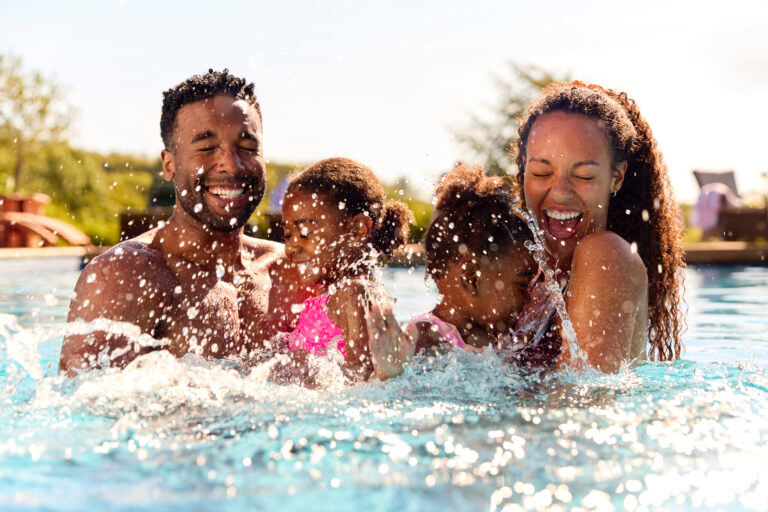 family splashing in the pool