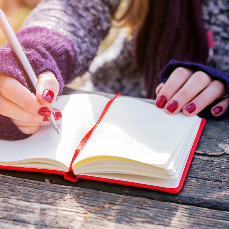 Hands writing in red notebook - who the Your Final Matters Letter of Wishes workshop is for