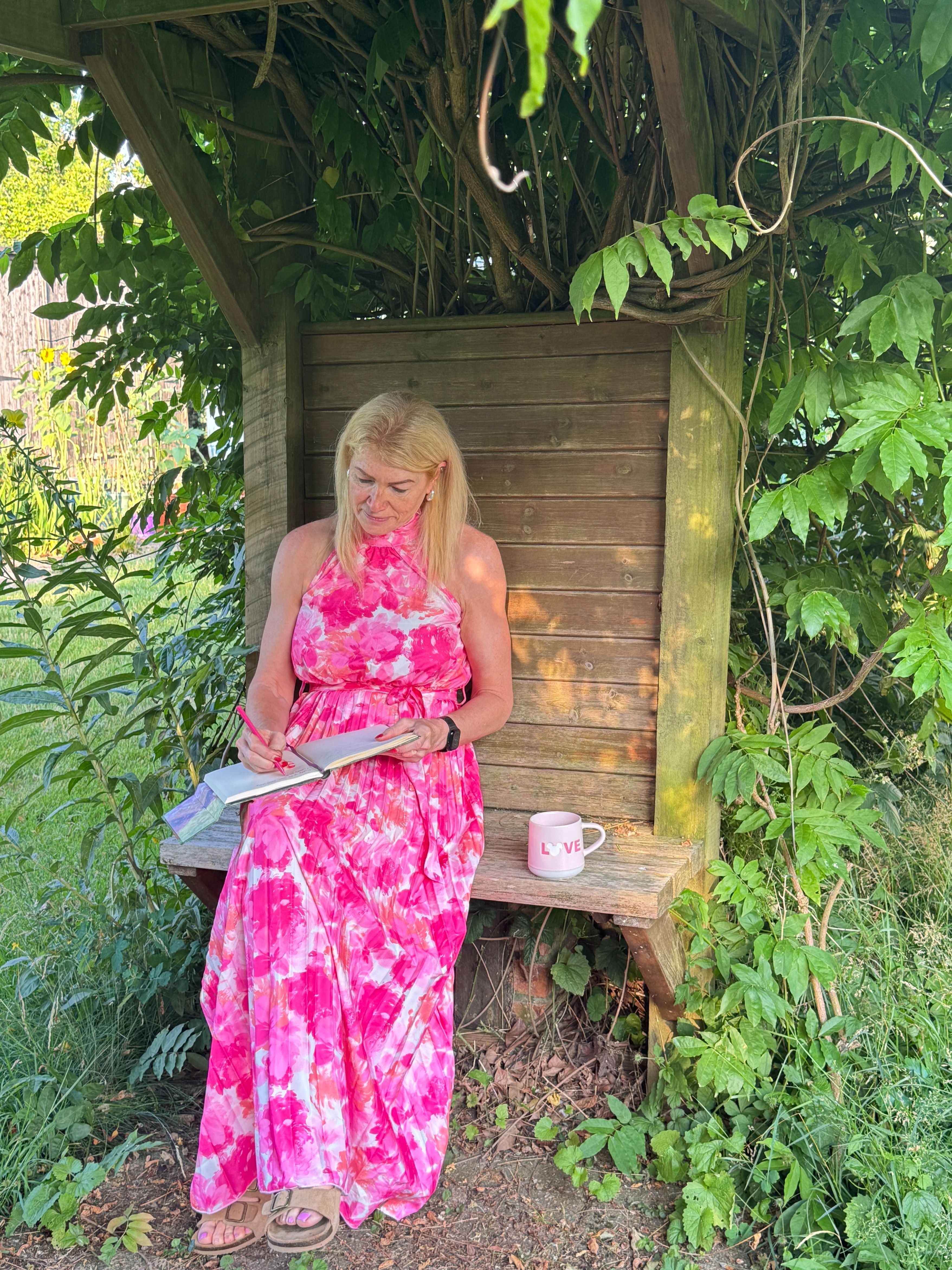 Caro Syson founder of Your Final Matters sitting in garden writing - Letter of Wishes workshop