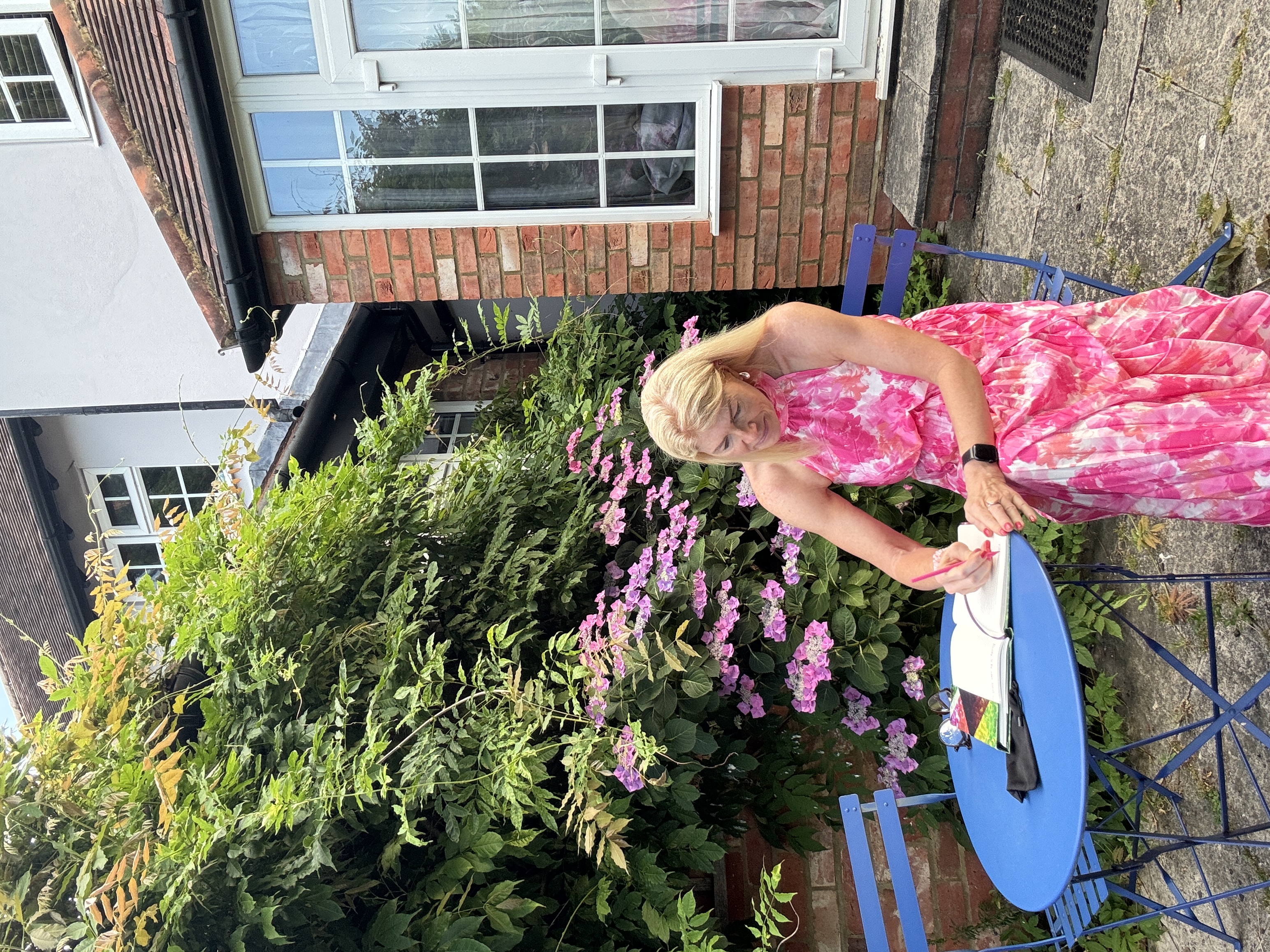 Caro Syson founder of Your Final Matters sitting in garden writing - Letter of Wishes workshop