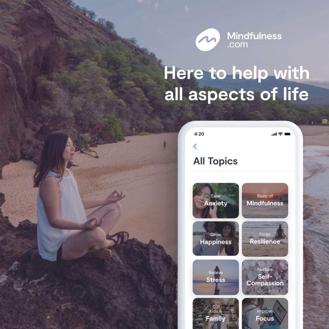 A woman meditating peacefully by the ocean at sunset with the Mindfulness.com mobile app interface displayed beside her, representing calm, focus, and emotional clarity.