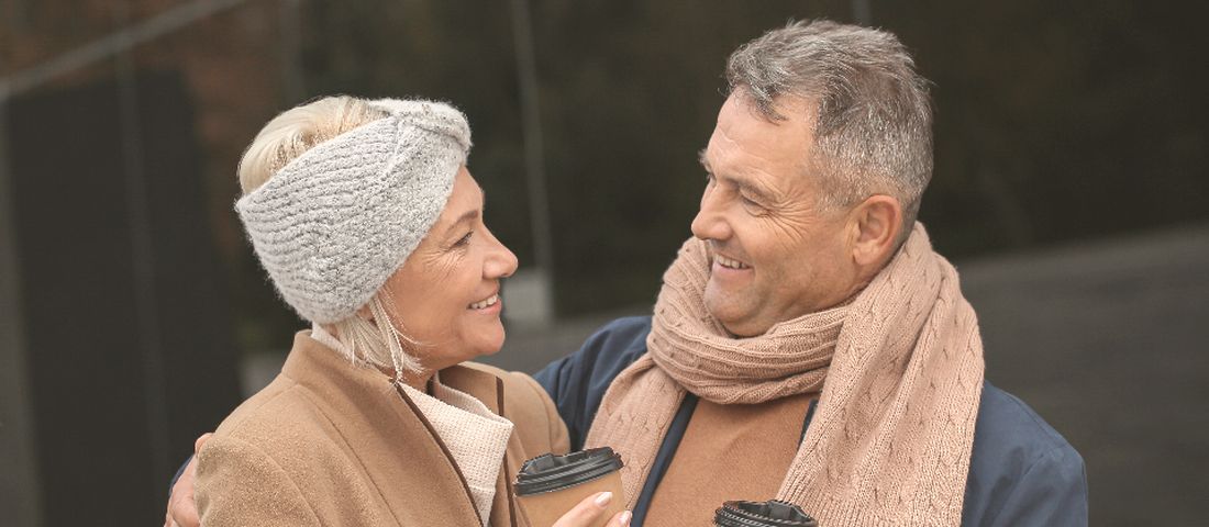 An older couple laughing over coffee: mood and testosterone travel together