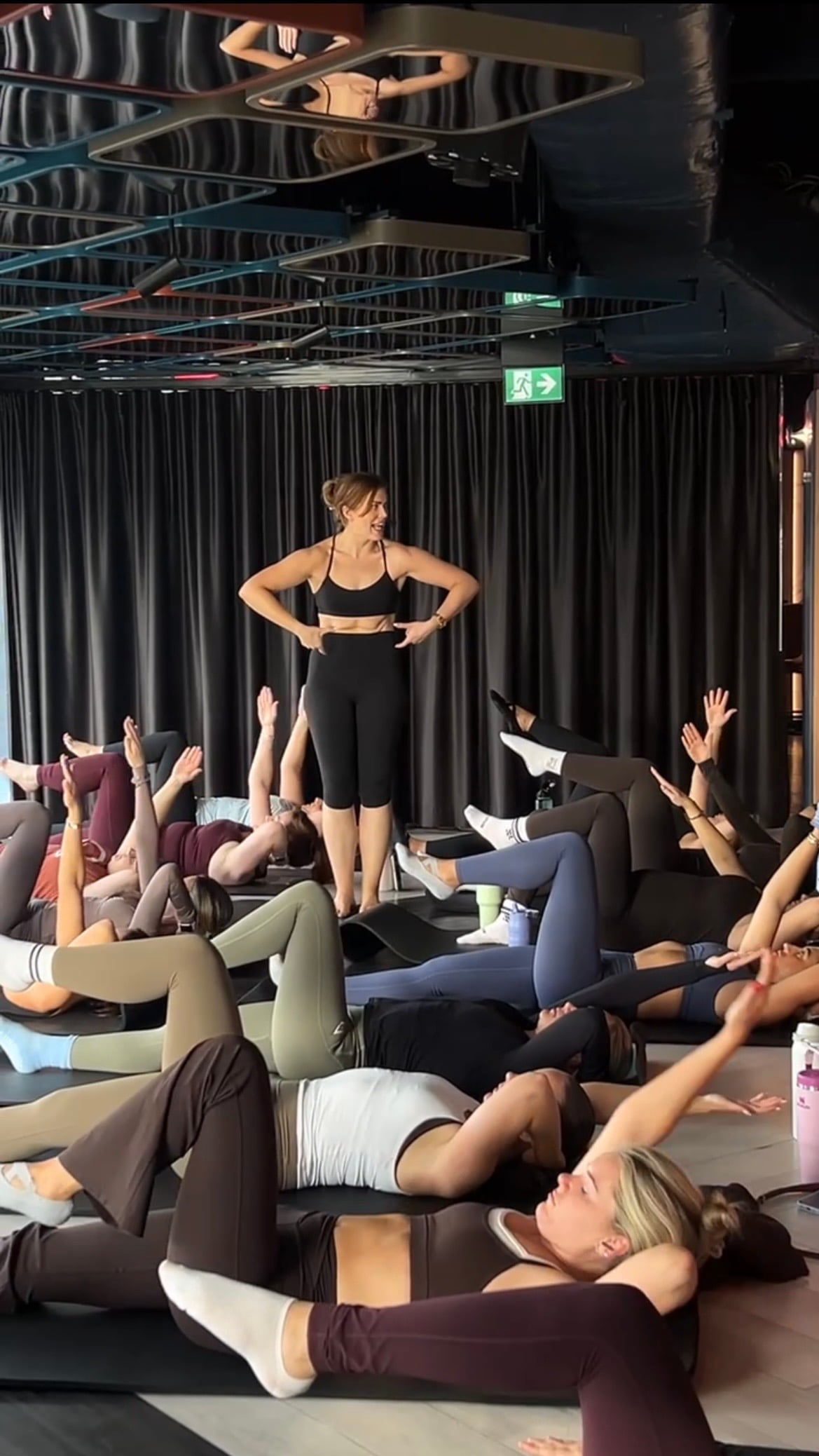 Jacks teaching a group Pilates wellness session