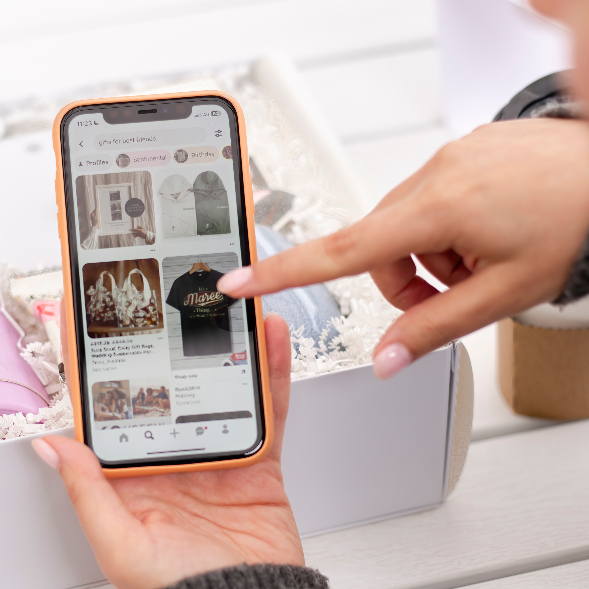 woman holding phone pointing at screen
