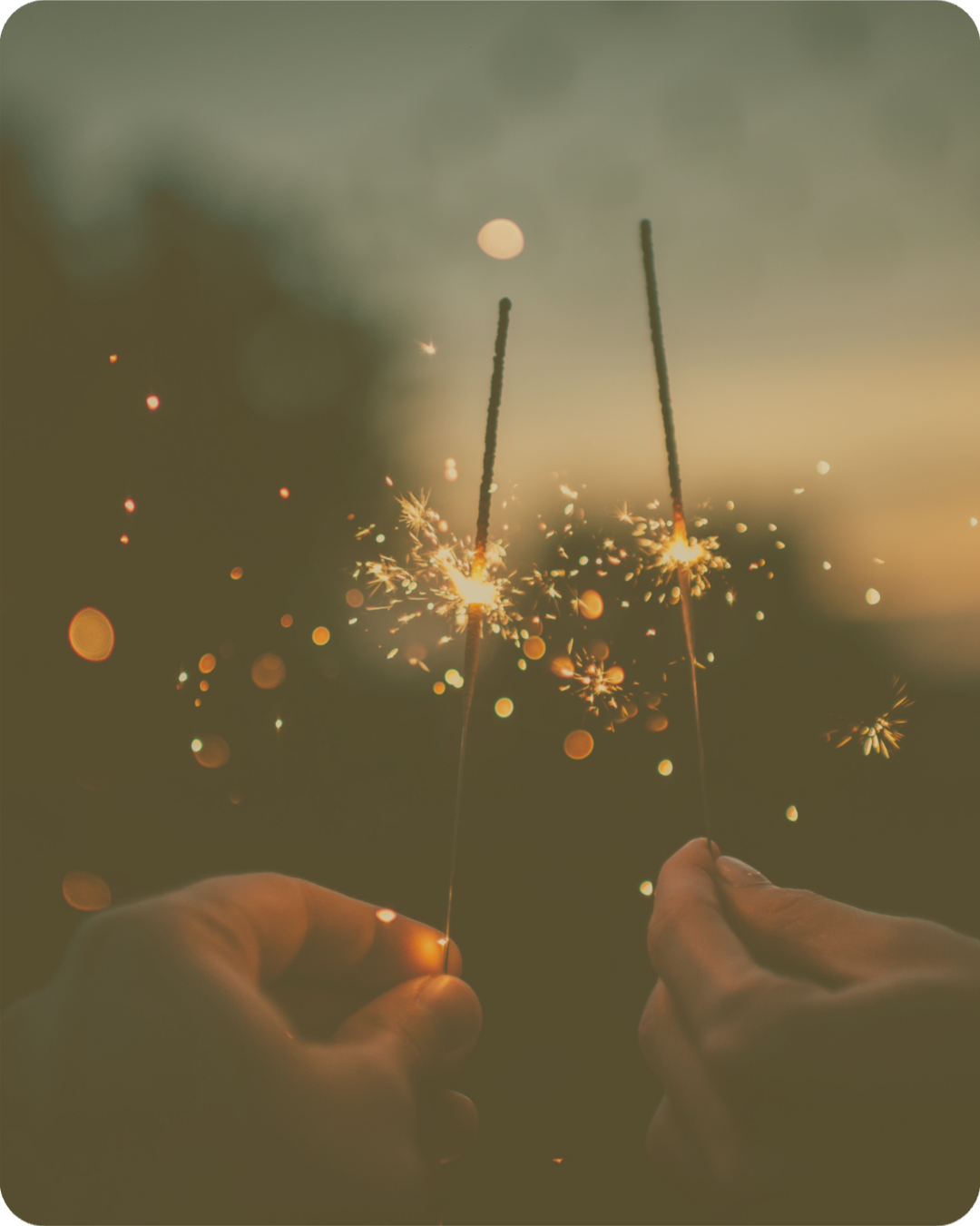 A hand holding a lit sparkler in the dark, symbolising a breakthrough moment and sudden clarity during a mindset coaching session.