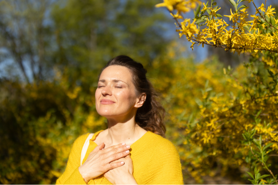 A woman looking directly at the camera, calm and grounded