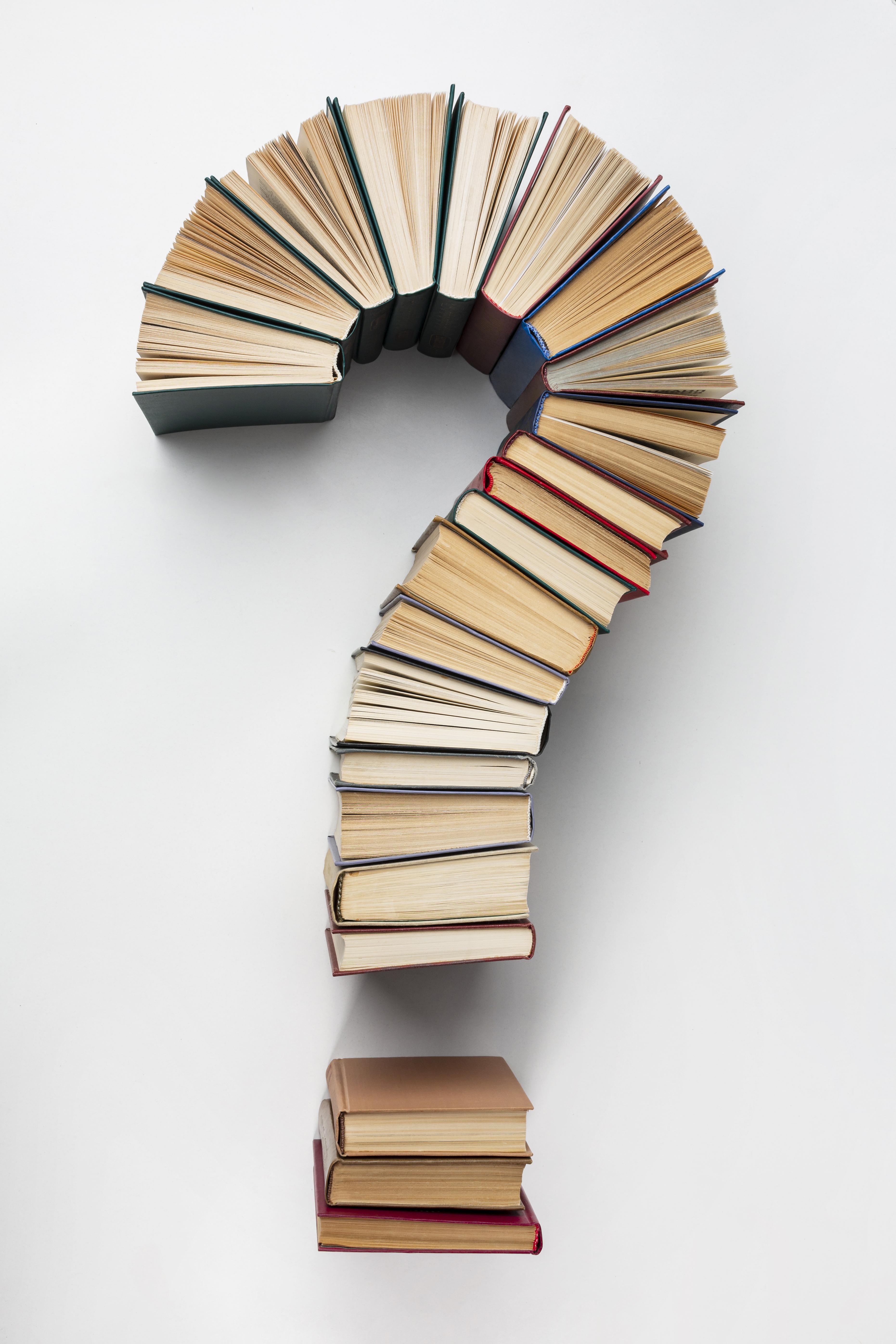 Stack of books arranged in the shape of a question mark, symbolizing the upcoming book 