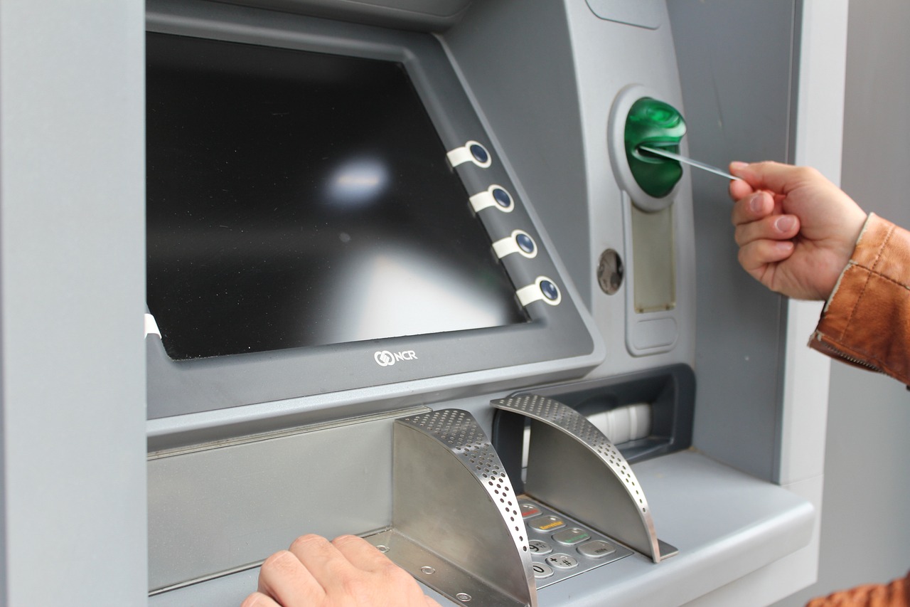 Inserting a debit card into ATM machine