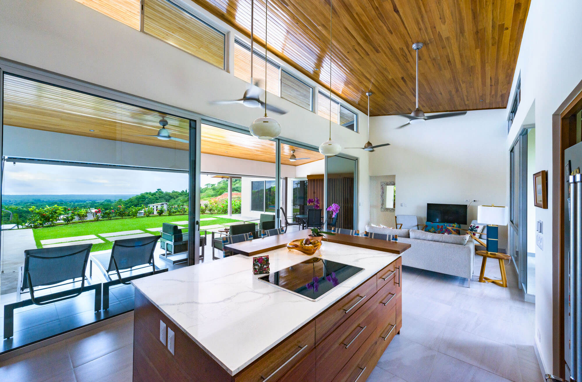 Modern open-concept home interior with panoramic forest and mountain views