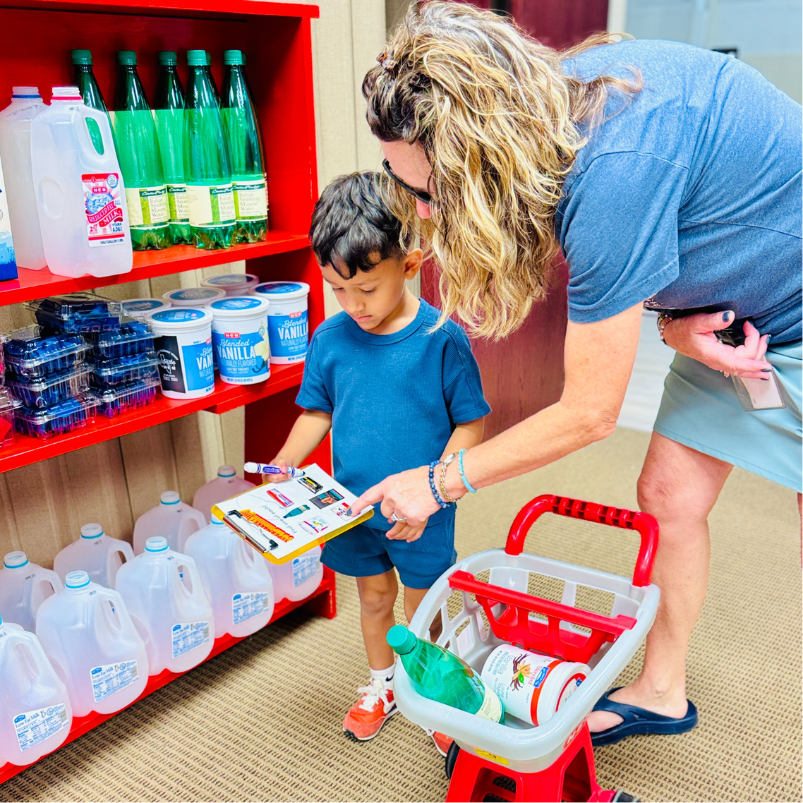 Preschool child doing a shopping spree at summer camp.