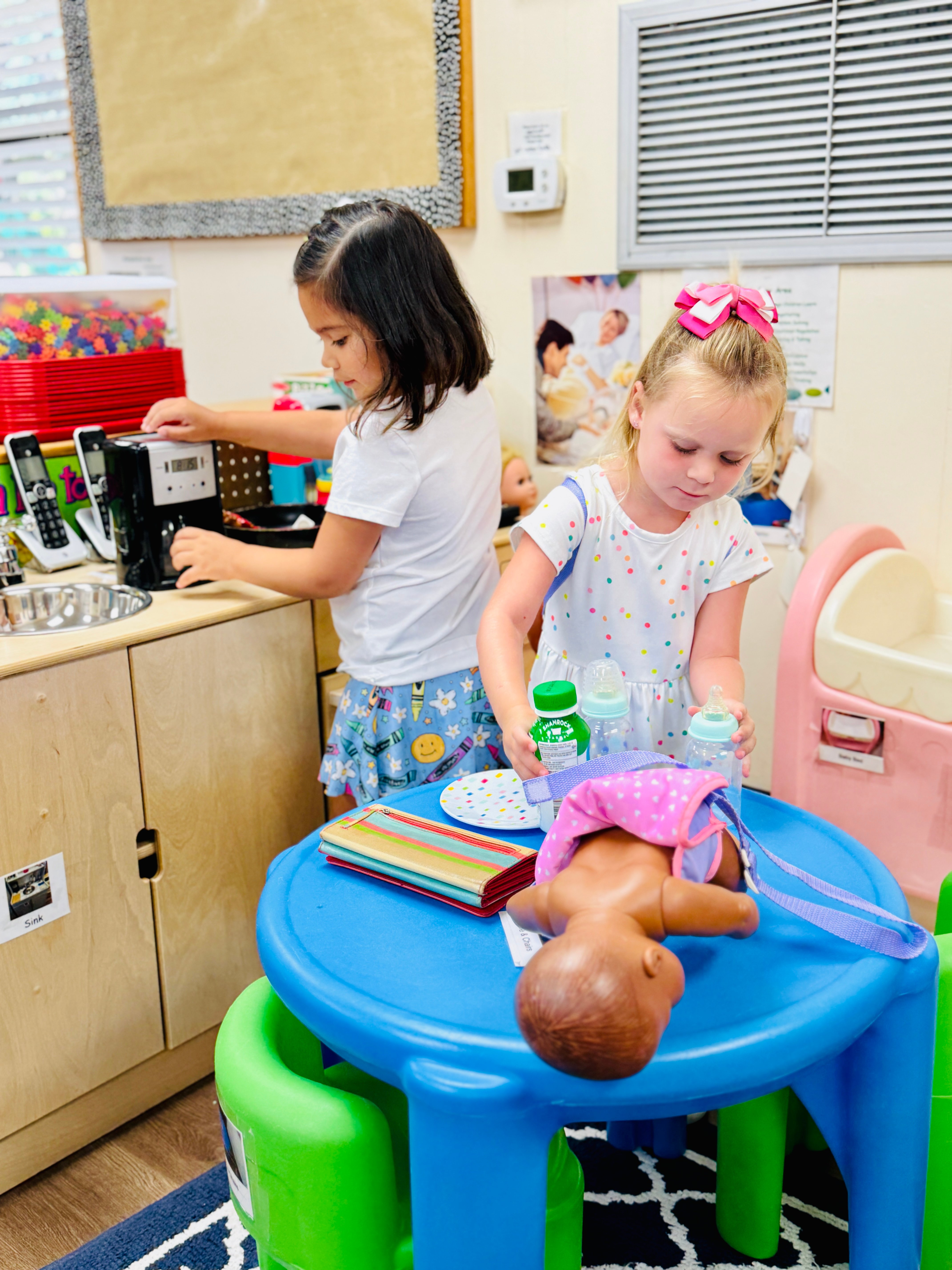 Two preschool children playing during center time.