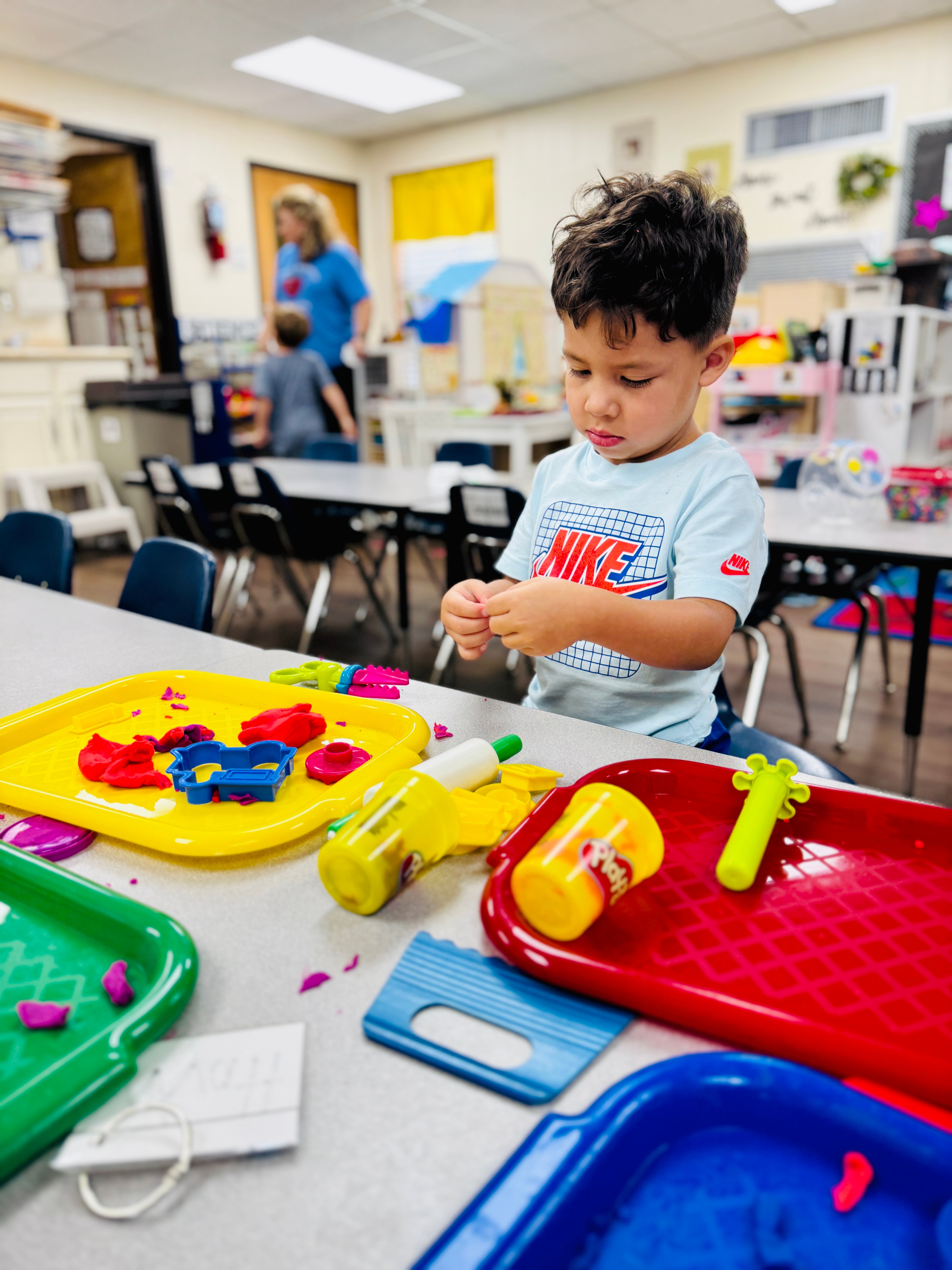 Transitional kindergarten child engaged in hands on learning.