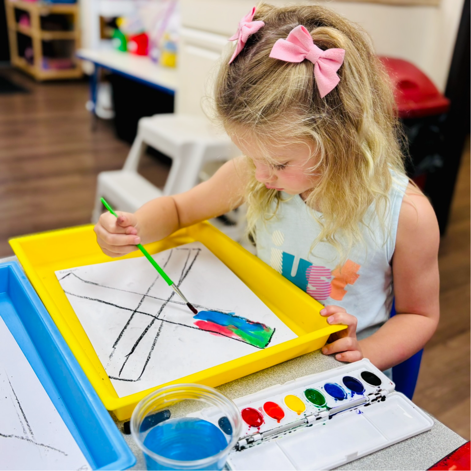 Preschool child doing art work at summer camp.