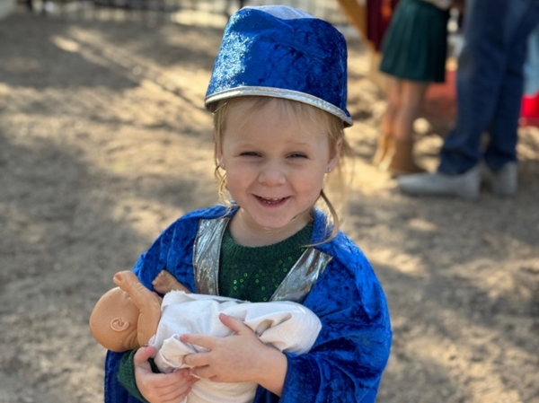 Child playing dress up on the playground.