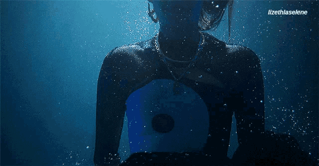 shadow work meaning: woman sinking underwater representing the shadow self