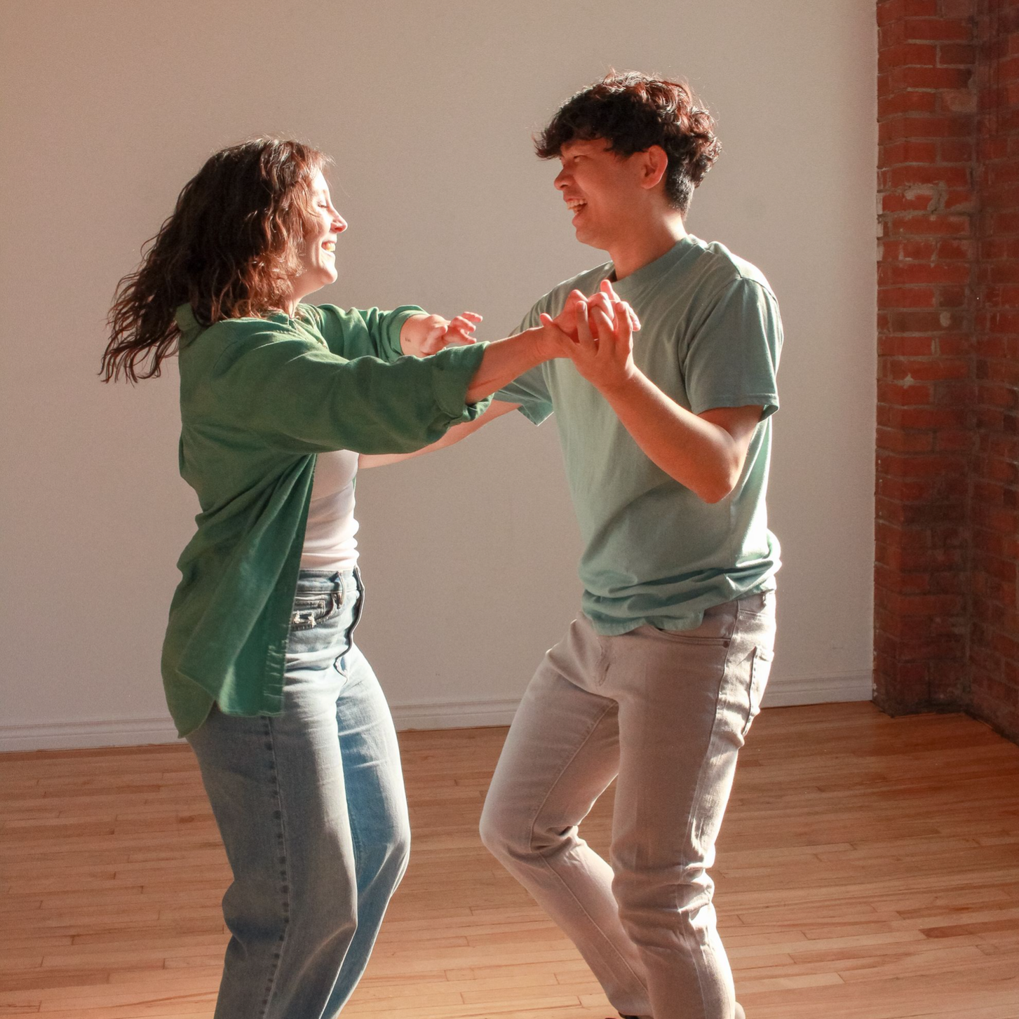 Kaylah and Steven in wraparound pose, looking at each other and smiling.