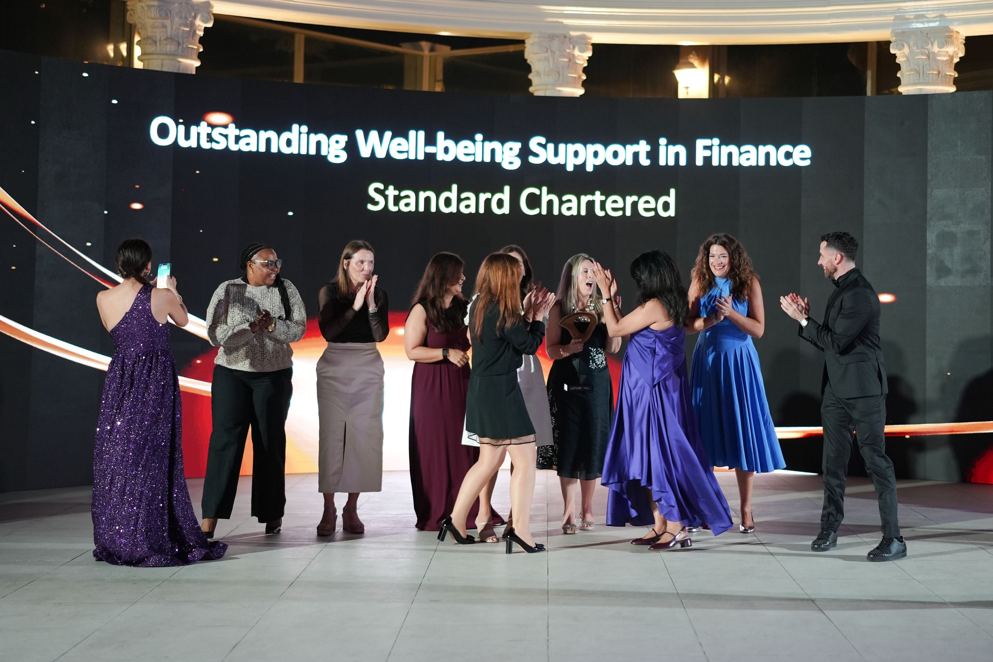 Standard Chartered colleagues applauding their award win at the mentl awards 2025