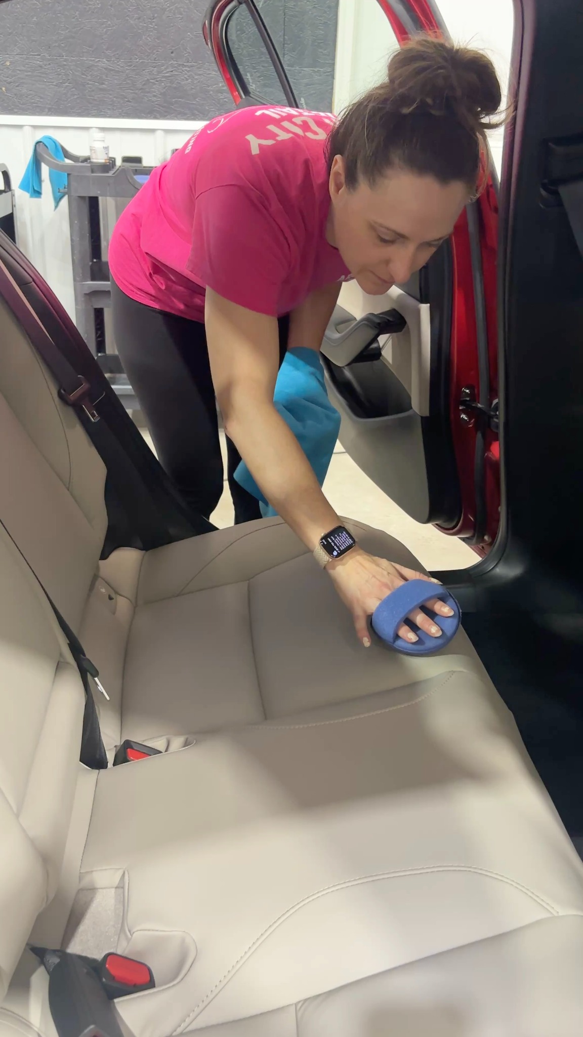 An Arch City Detail team member caring for a vehicle's seats