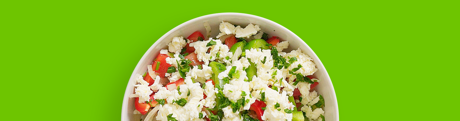 Top-down shot of a plate of colorful and tasty Bulgarian Shopska salad