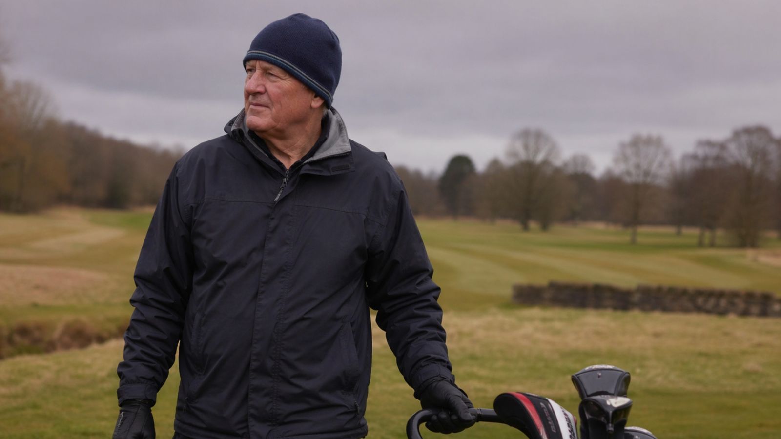Older golfer in winter golf clothing on the course