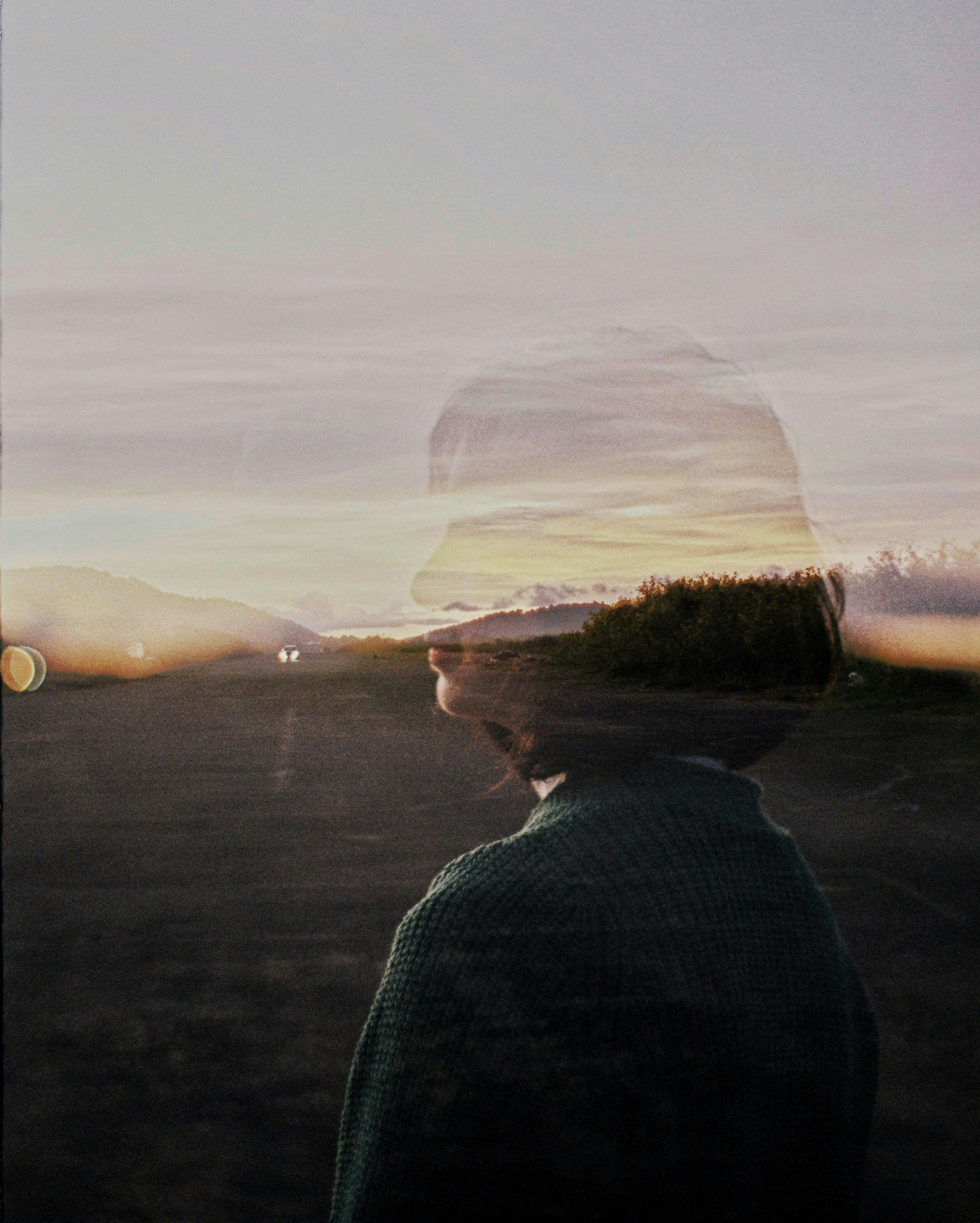 Transparent silhouette of woman on mountain path during reflective travel coaching phase one rediscovering travel self