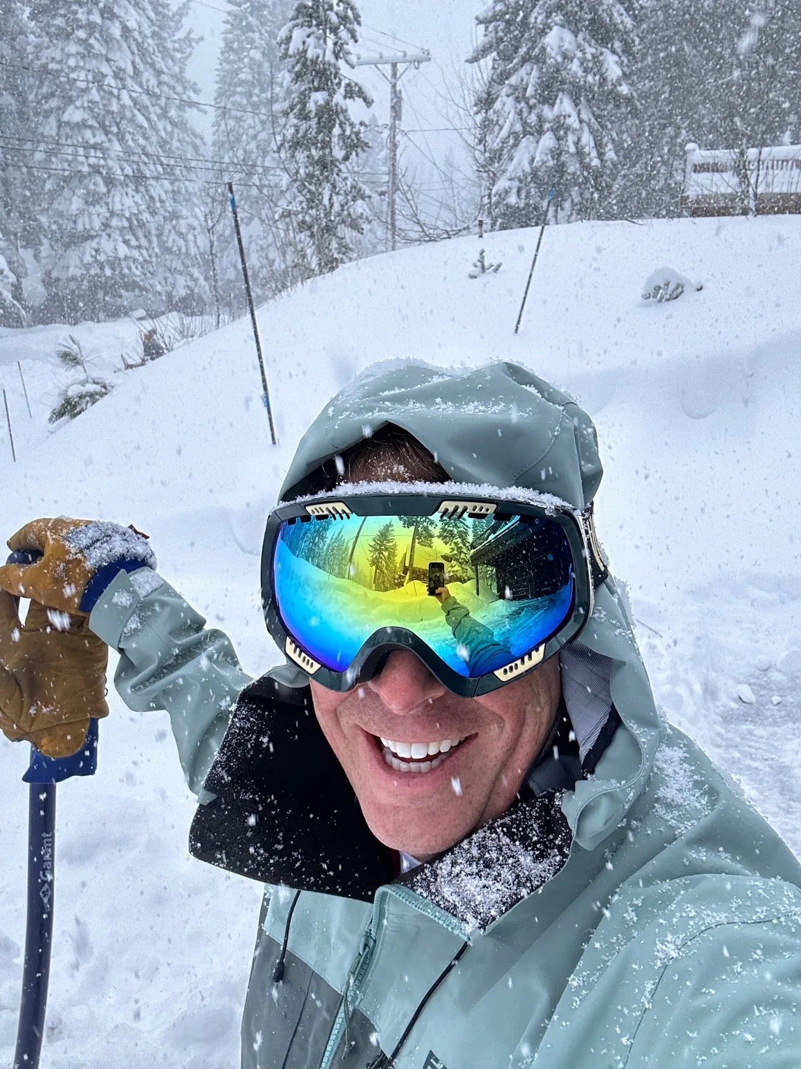 Ryan J. Kime smiling in ski goggles during a snowy day on the mountain